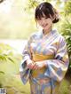 A woman in a blue and yellow kimono posing for a picture.