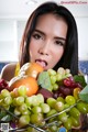 A woman holding a basket full of fruit in her hands.